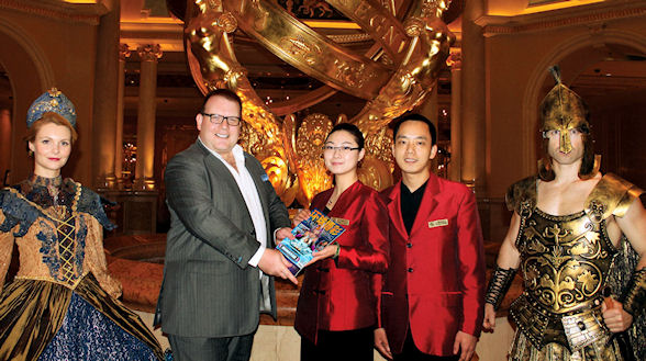 WGM CEO Andrew W Scott hands over the millionth copy of World Gaming magazine to guest relations staff at the Venetian Macau, where over 100,000 copies of WGM have been distributed since early 2010